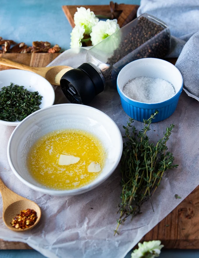 Savory ingredients including melted butter, garlic powder, salt and fresh thyme