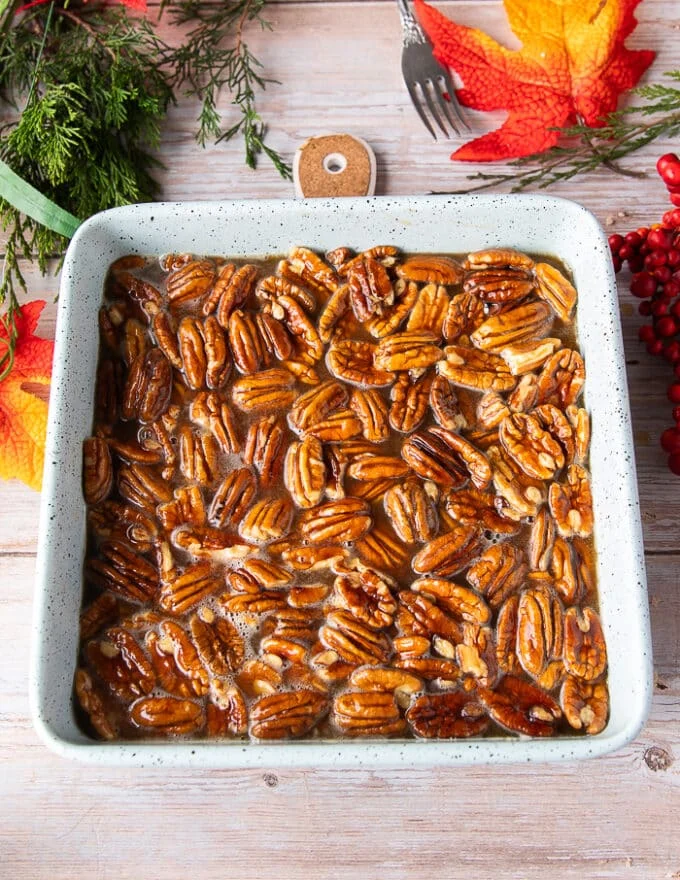 Pecan pie filling is now poured over the crust and ready to go into the oven to bake