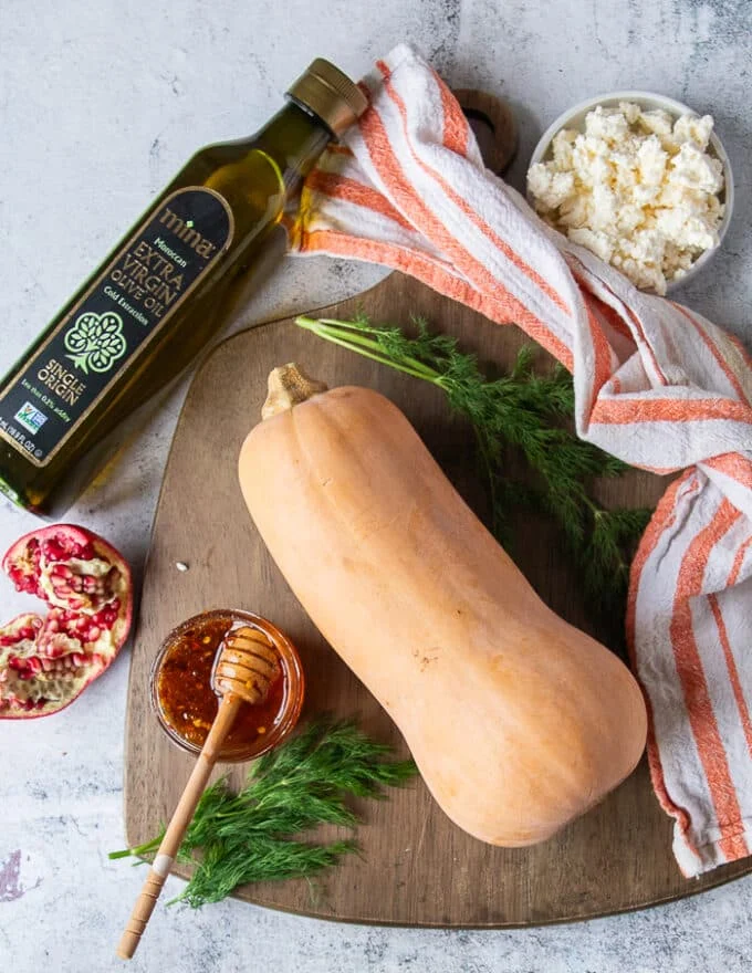 Ingredients to roast butternut squash including a butternut squash, salt and pepper and olive oil