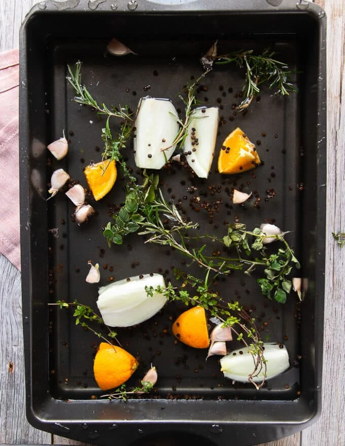 All the brine ingredients mixed together in a large roasting pan