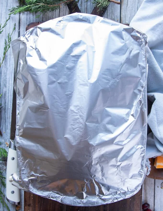 The baking pan is covered with foil and the turkey sliders are ready to go in the oven now