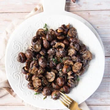 A plate of air fryer mushrooms and a fork in the plate