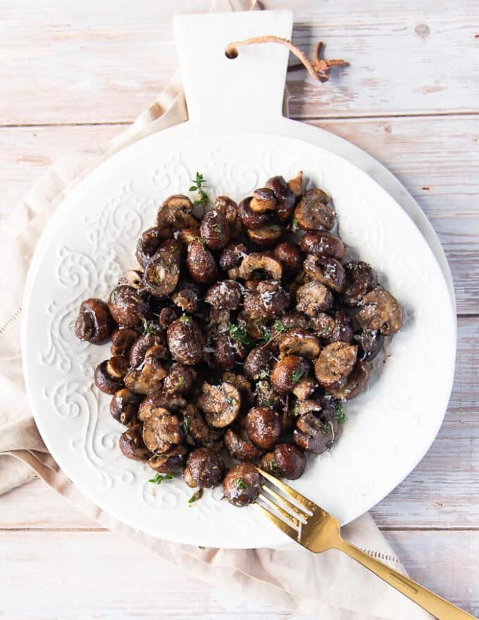 A plate of air fryer mushrooms and a fork in the plate