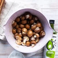 The mushrooms are tossed in a large bowl with the salt, pepper, soy sauce and oil