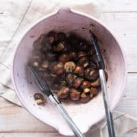 The mushrooms tossed in the melted butter, garlic and parmesan mixture in a bowl