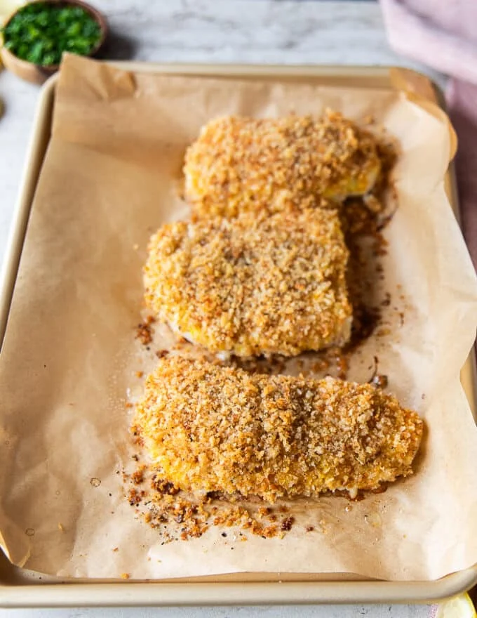 cod fillets on a baking sheet out of the oven
