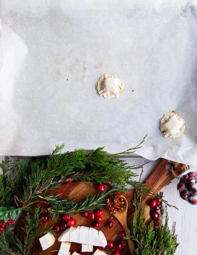 A piece of puff pastry encompassing the brie and honey on top