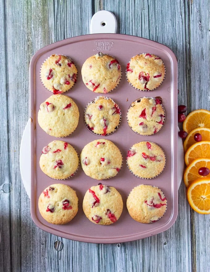 The baked cranberry orange muffins in the muffin pan ready and out of the oven