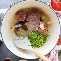 The ground beef, garlic, cilantro, and spices are added to the pot with the onions to cook the taco soup