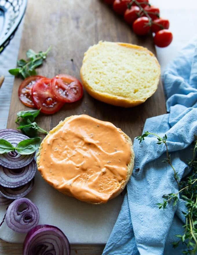 Burger buns spread generously with spicy mayo