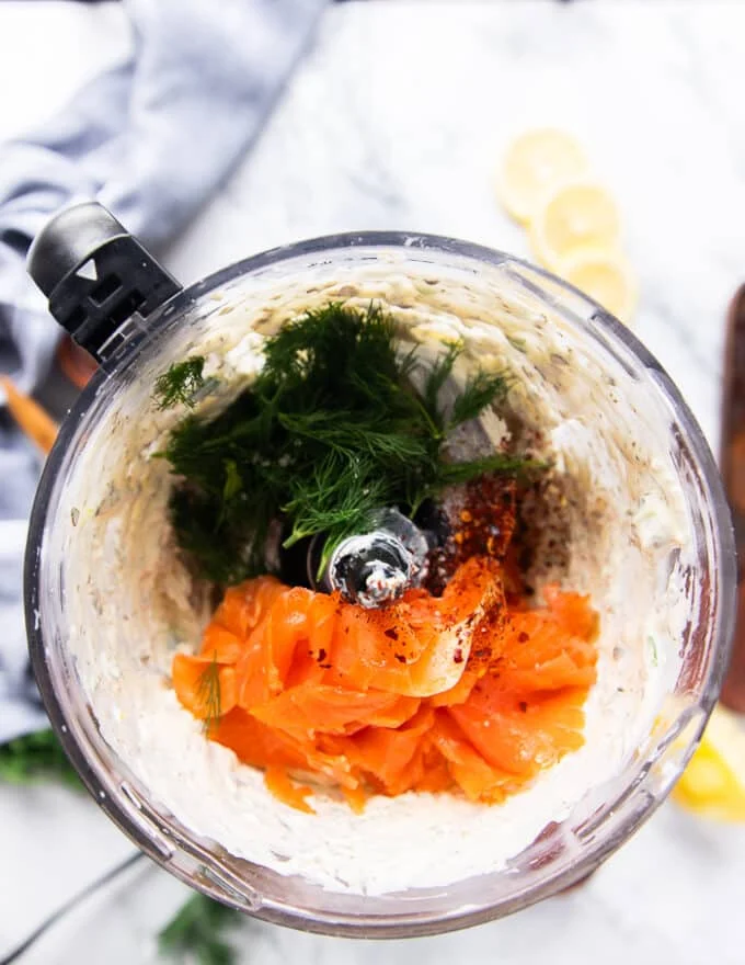 The smoked salmon and dill added to the smooth cream cheese mixture in the food processor