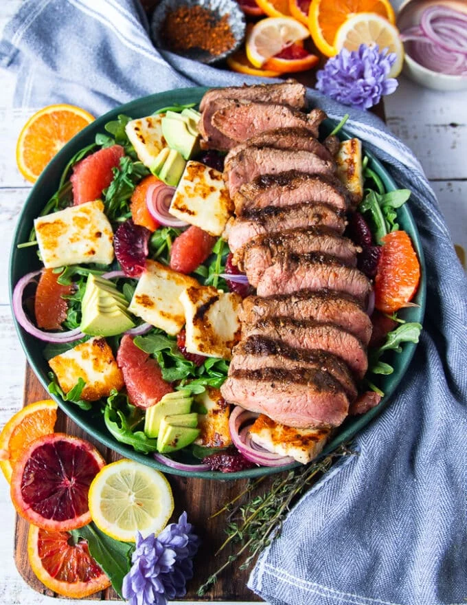 Sliced Lamb Loin cooked and served over the halloumi salad