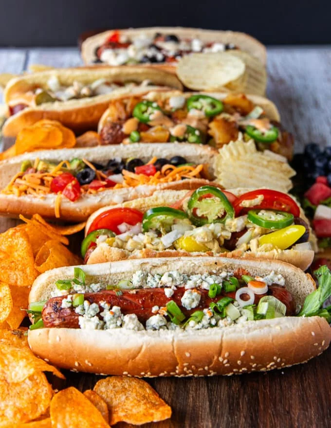 side view of the speciality grilled hot dogs made form the hot dog bar assembled on a board