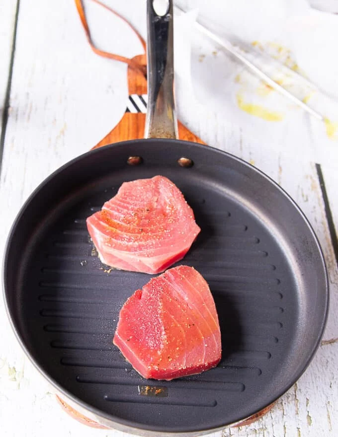 Tuna steaks in a grill pan cooking