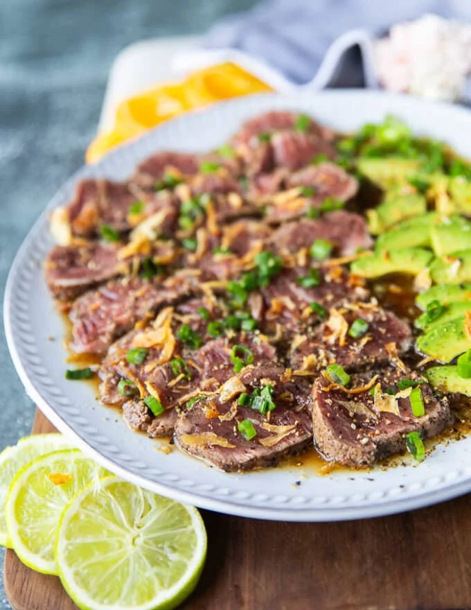 close up of beef tataki showing the texture of the meat and the crisp toppings