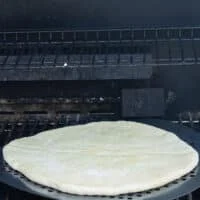 pizza dough placed on the grill