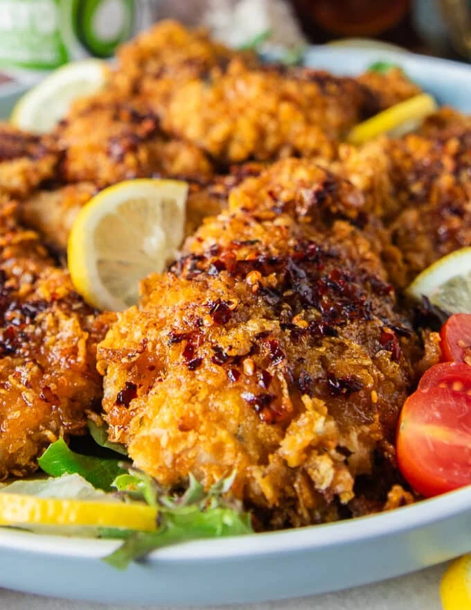 close up of one hot honey chicken tender dressed up with hot honey