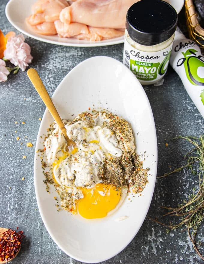 All the wet coating ingredients are added to a shallow plate with a fork used to mix them.