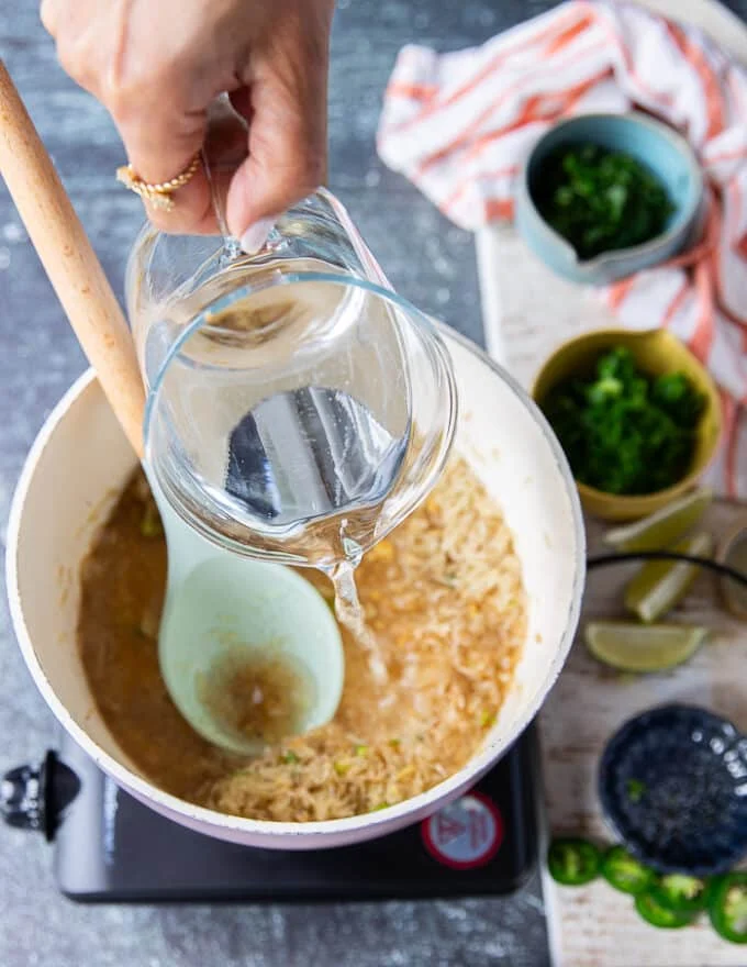 water added to the rice so it can cook