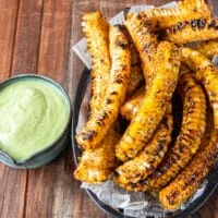 perfectly golden and crisp corn ribs in a basket ready to serve