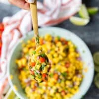 a spoonful of mango pico de gallo close up showing details of the pico