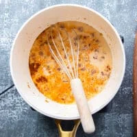 Milk is added to the pot for the queso recipe