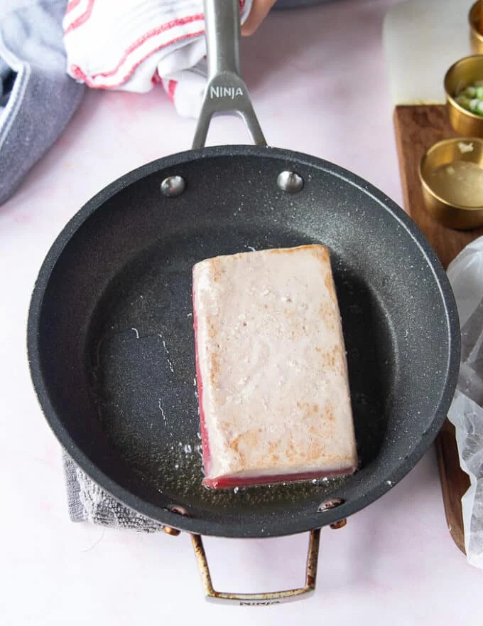 the tuna flipped on the other side for cooking another minute