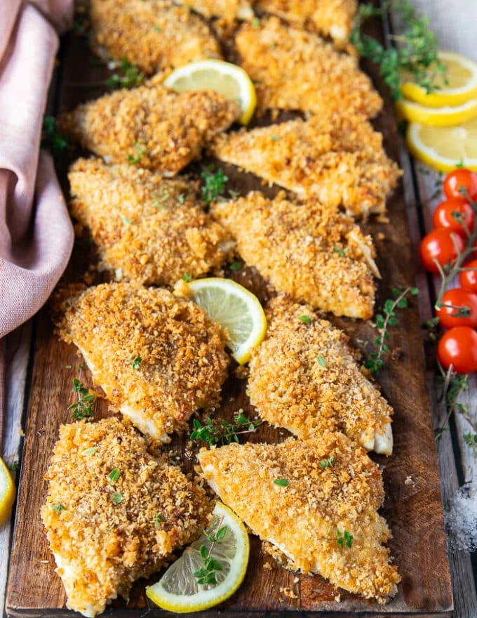 Side view close up of baked perch recipe on a board showing the texture and cooked fish