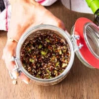 All chili oil ingreidnets are added into a wide mouth jar like salt, sugar, chilli flakes, ginger, garlic, scallions