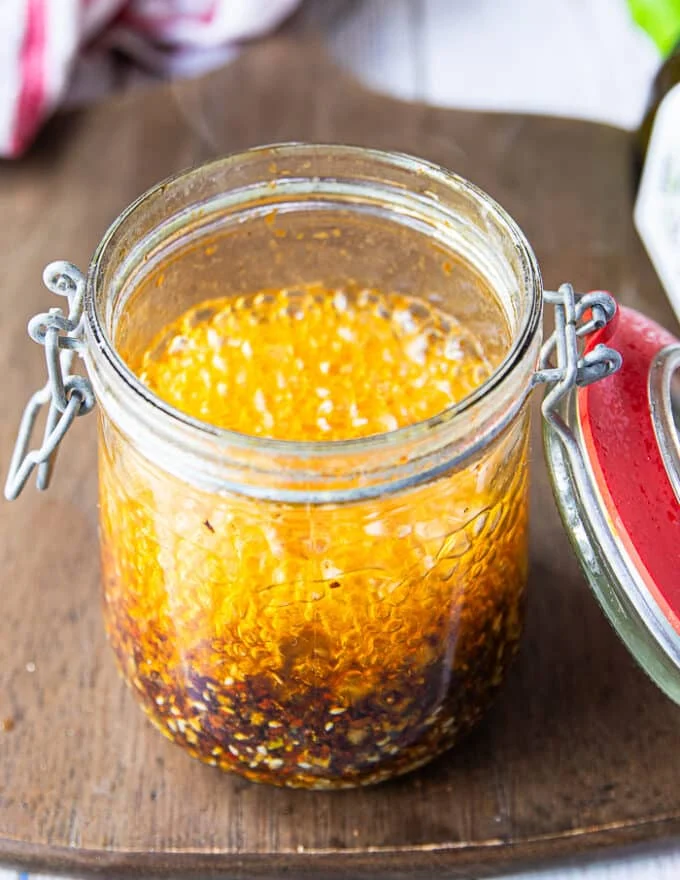 A close up of the bubbling hot oil in the jar as it hits the chilli powder and other ingredients