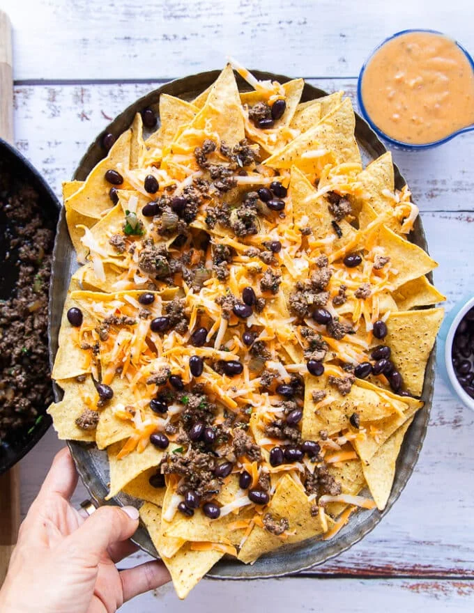 the plate of nachos ready to go in the oven
