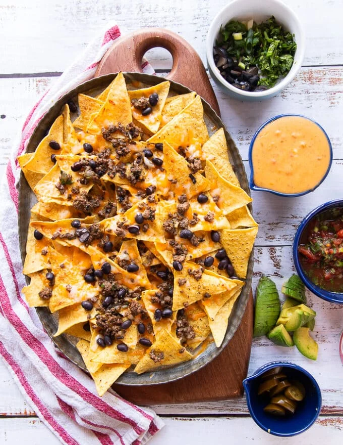 cheesy nachos out of the oven ready for the toppings