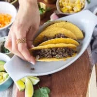 the ground beef is now added over the cheese in the taco shell