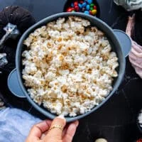 the popped kernels in the popcorn maker ready
