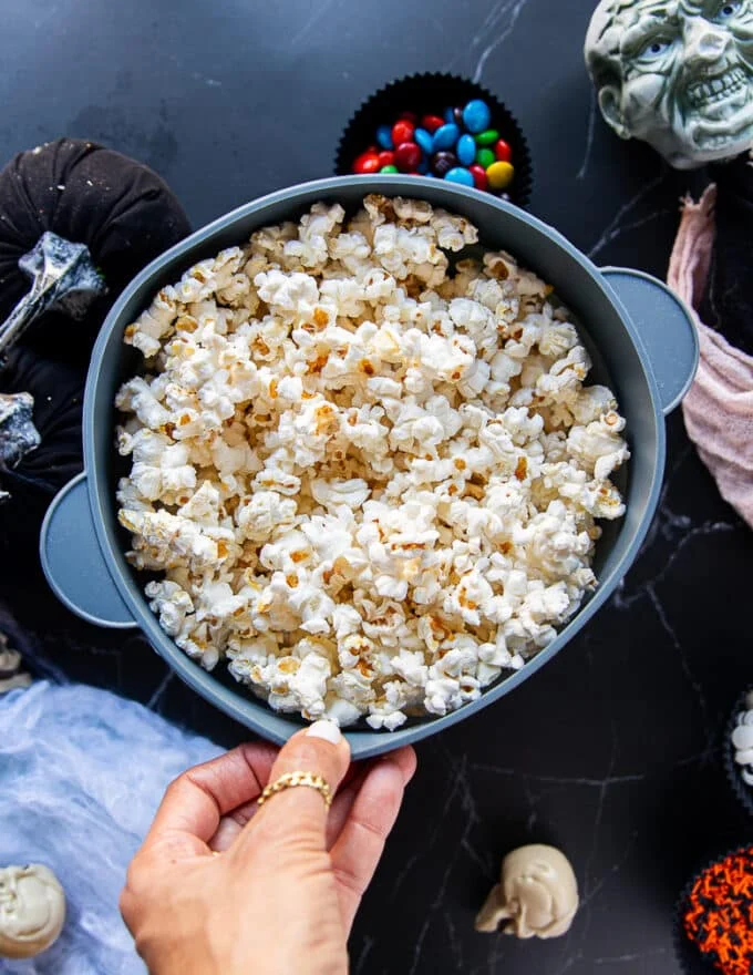 the popped kernels in the popcorn maker ready