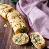 perfect air fryer garlic bread removed form the air fryer into a board and the slices slightly separated by pulling apart
