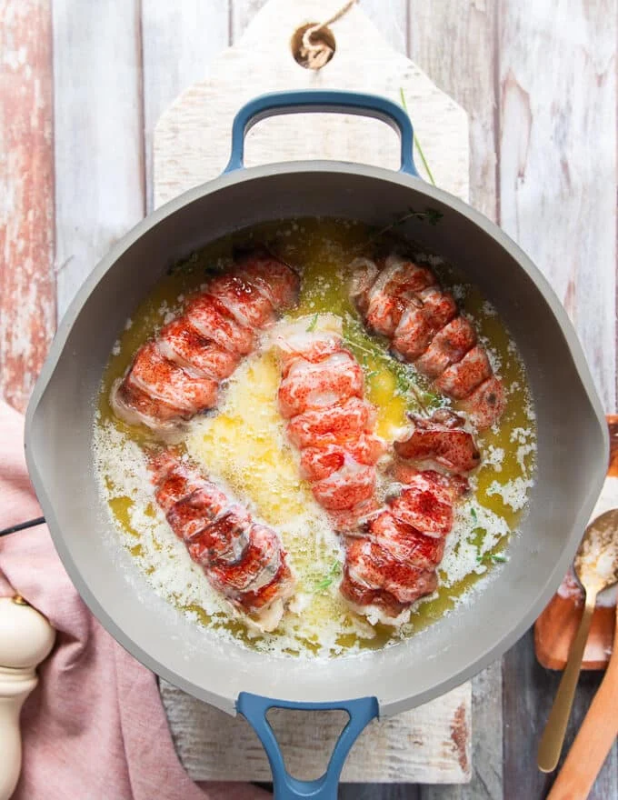 lobster tails are added to the butter mixture in the saucepan
