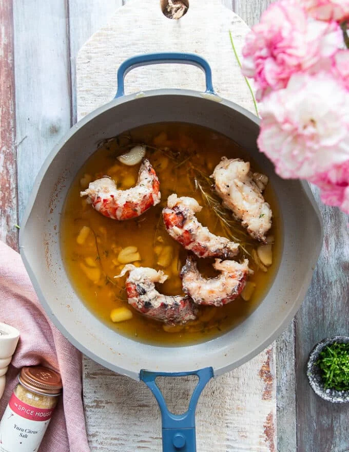 Fully cooked lobster tails in the butter sauce now ready
