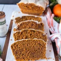 sliced pumpkin bread on a white board showing the texture and moist crumb close up