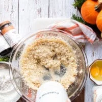 A hand mixer beating the butter, oil , light brown sugar and white sugar in a large bowl