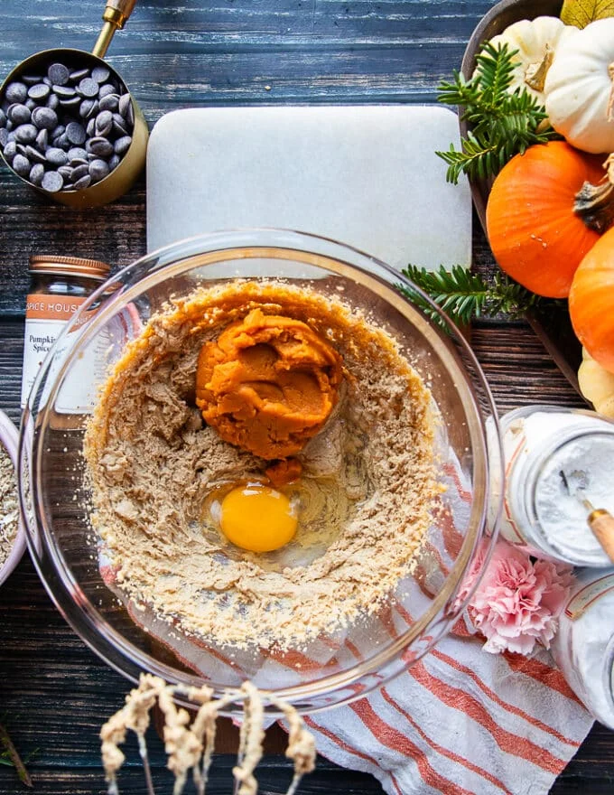 The egg yolk and pumpkin purée, pumpkin spice and vanilla are added to the bowl of butter and sugars