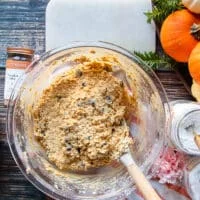A spatula folding on the chocolate chips and oats for the pumpkin oatmeal cookies