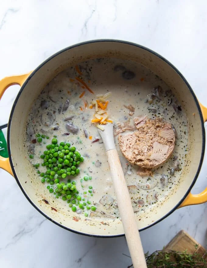 The tuna, green peas and cheese are added to the pot once the sauce has boiled