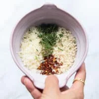 topping ingredients all mixed in a bowl which is panko bread crumbs, thyme, chilli flakes lemon zest