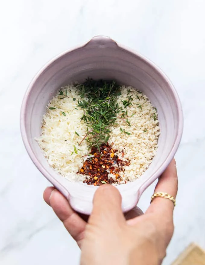 topping ingredients all mixed in a bowl which is panko bread crumbs, thyme, chilli flakes lemon zest