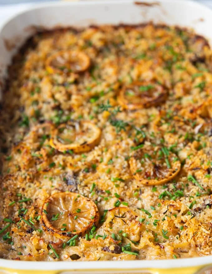 close up of the baked tuna casserole showing very up close the texture of the golden panko and caramelized lemons