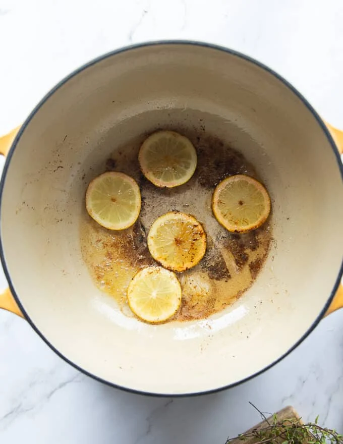 lemon slices caramelizing in the bottom of the pot