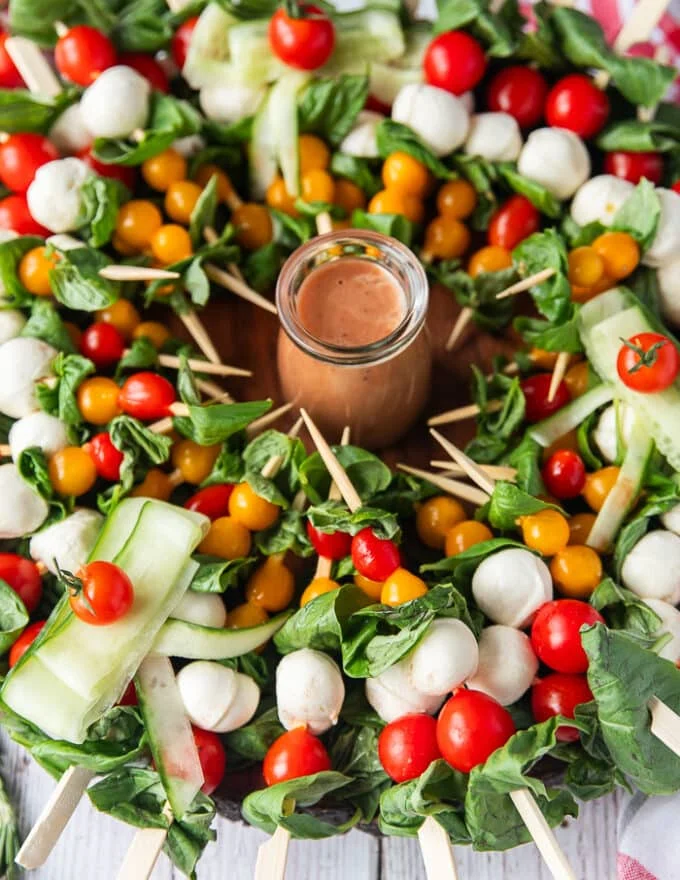 The full caprese wreath with a jar of dressing in the middle