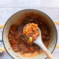 tomatoes are added to the pot and cooked until thickened