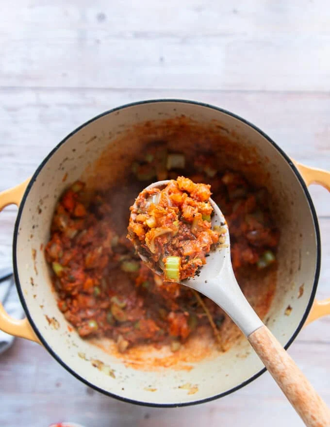 tomatoes are added to the pot and cooked until thickened
